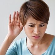 woman suffers from hearing impairment, hard of hearing, hearing loss, acoustic or ear problem, deafness with text space